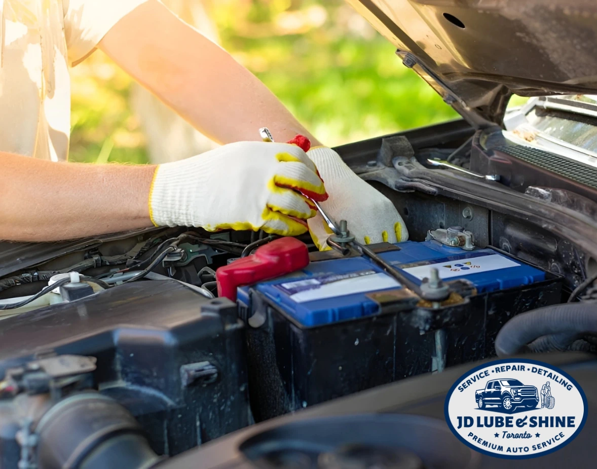 Technician replacing car battery during mobile battery replacement service in Canada